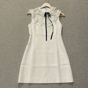 Crème coloured cocktail Dress with upper lace trim.